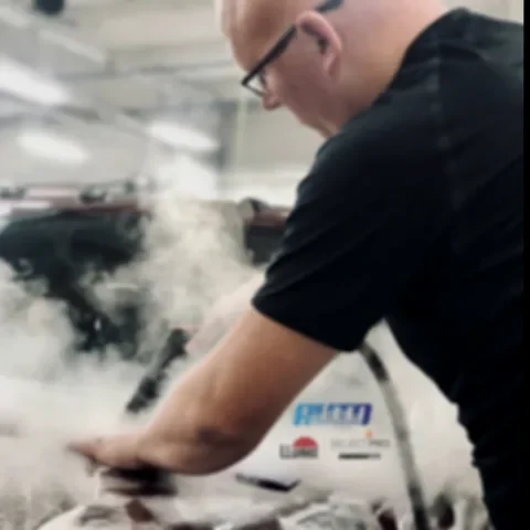 Brad Rhodes working on a vehicle in the Auto Obsessions bay