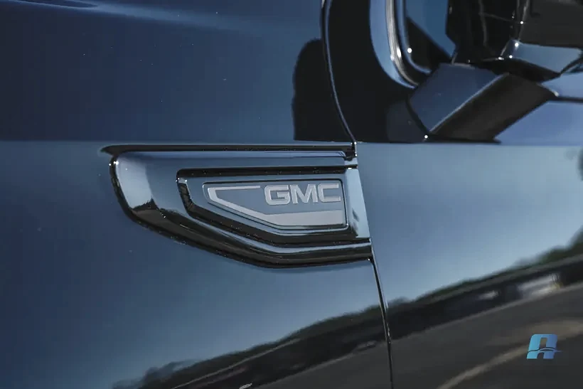 Blacked out GMC badge after a blackout coating on a Yukon