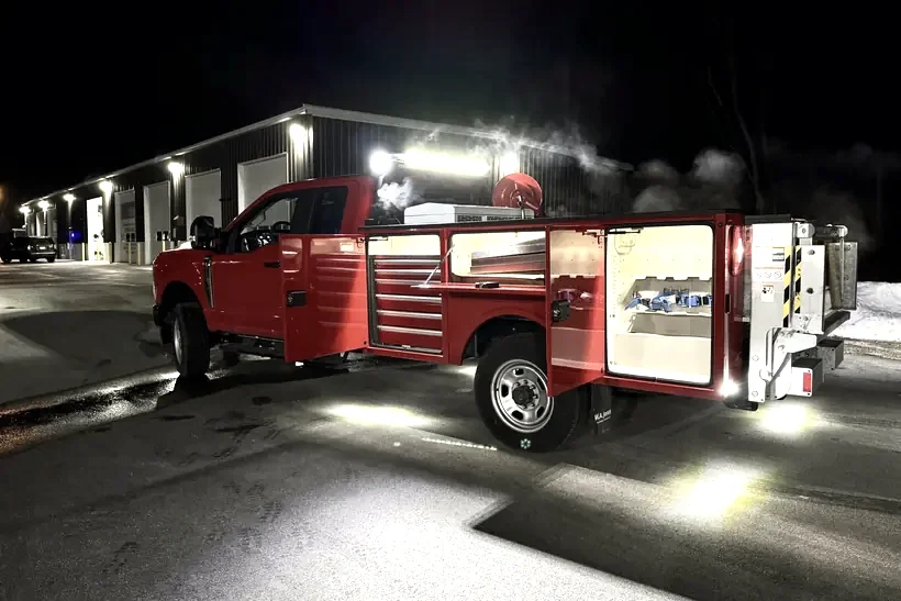 Emergency service truck at night with scene and compartment lighting installed